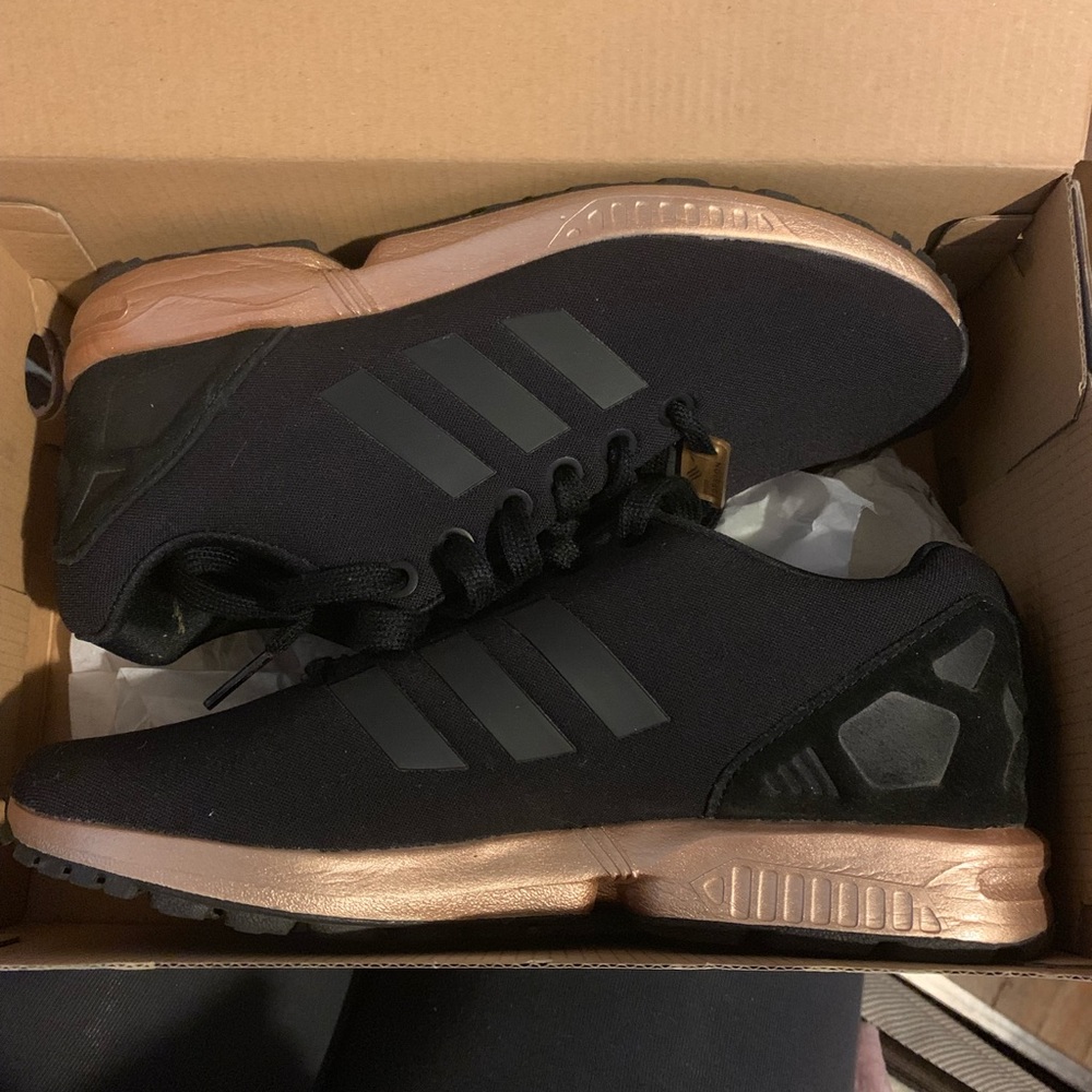 Black and rose gold adidas sneakers